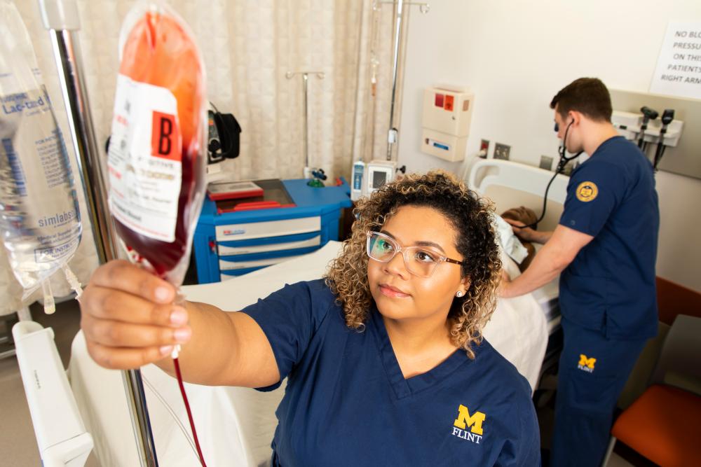 Student checking equipment in simulation lab
