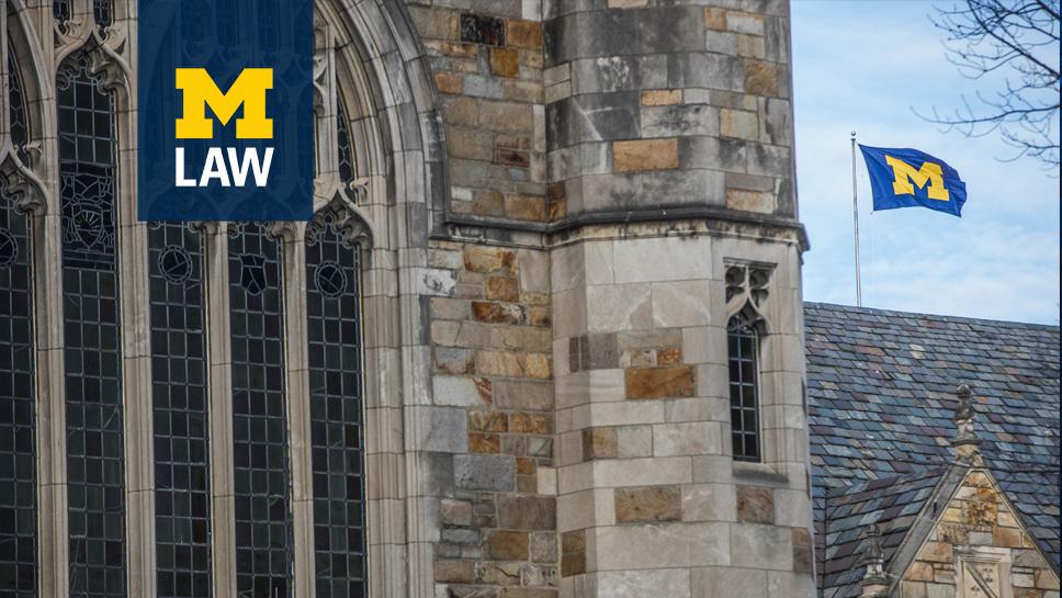 University of Michigan Law School facade with a Block-M flag in the background
