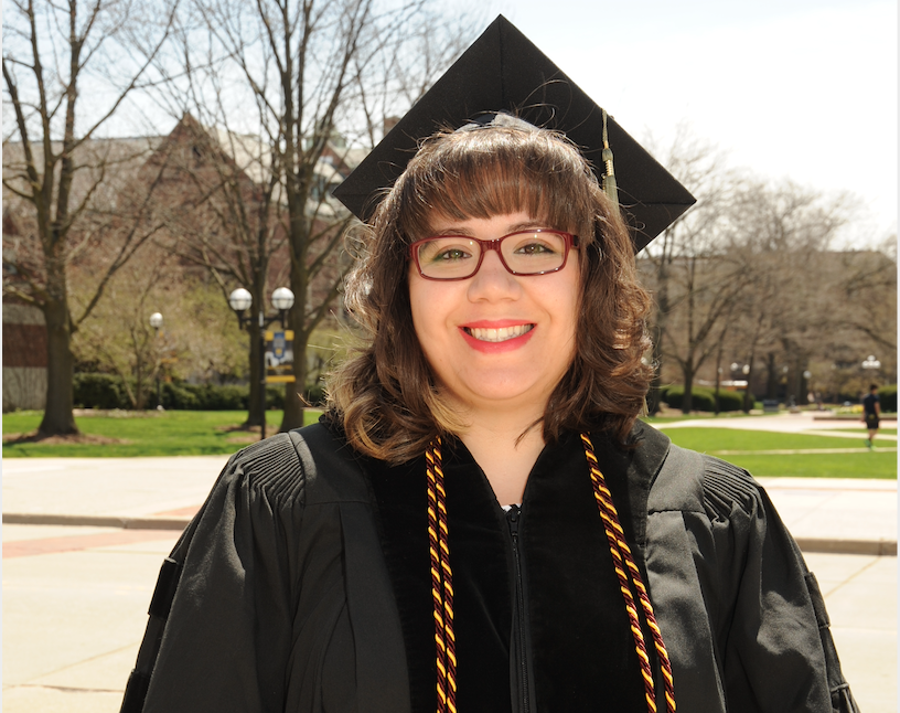 Maria Luz Ali in her graduation gown at commencement.