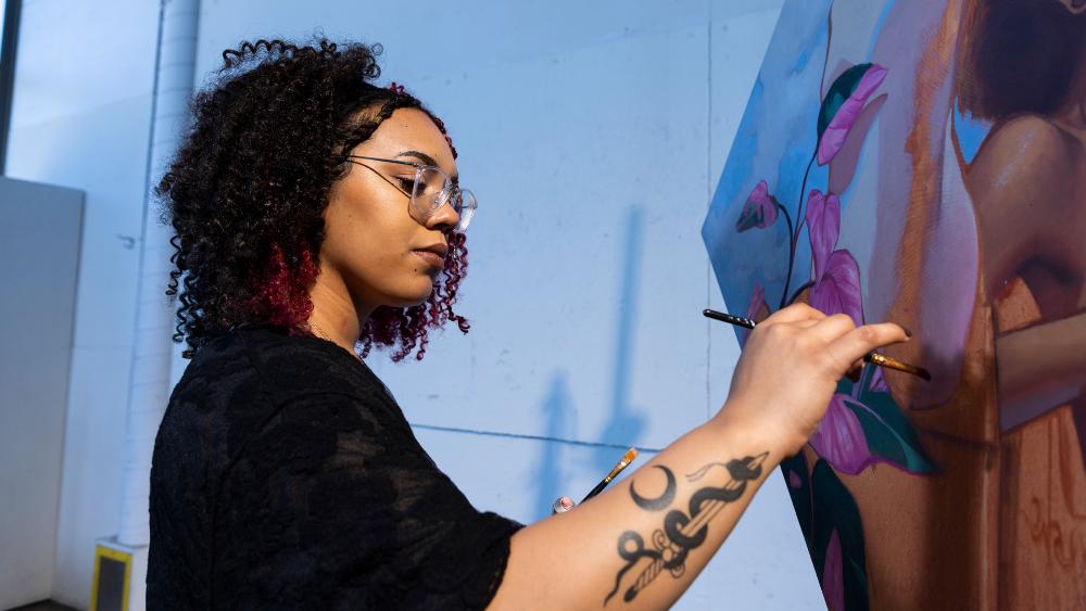 Stamps student painting a portrait