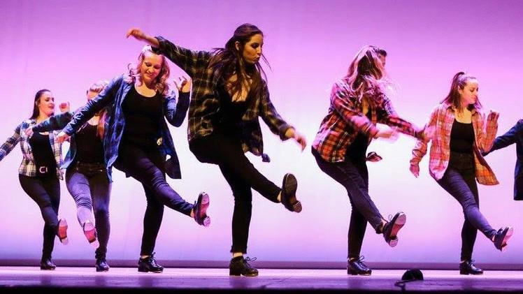 A group of students performed a tap routine on stage 