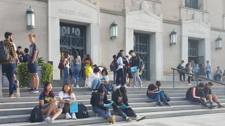 Students gather on the staircase in front of Rackham.