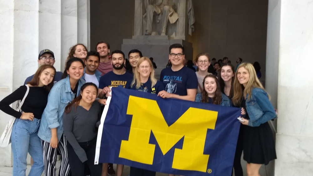 Michigan students hold a Michigan flag at the Lincoln Memorial