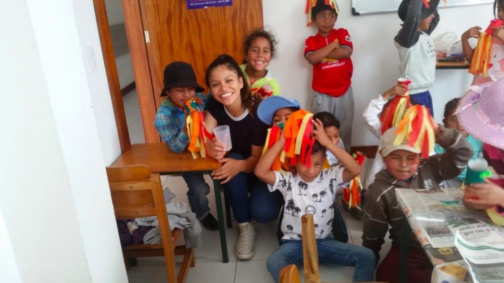 A Michigan student poses with children during her international trip