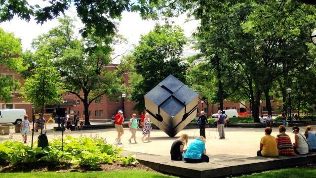 People walking around the Cube 