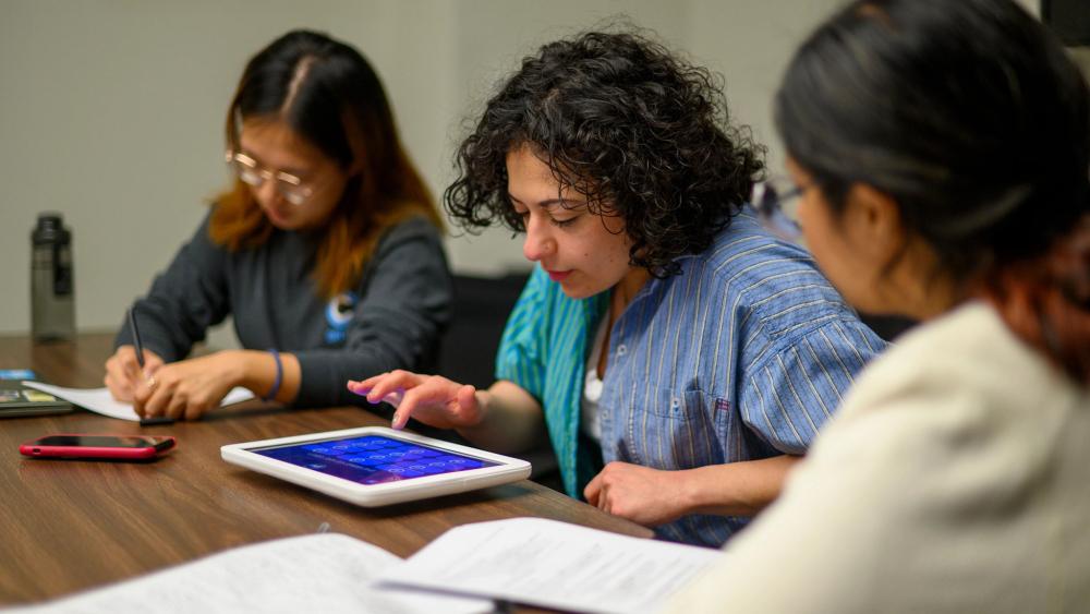 Students working together on an ipad