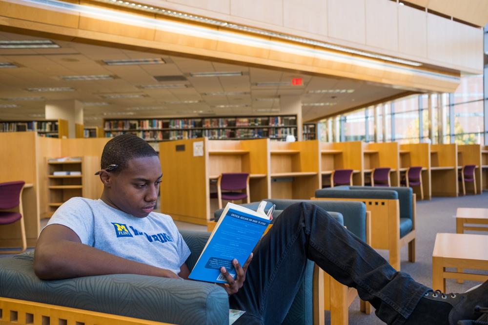 Student reading in library