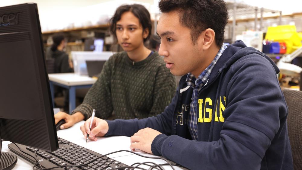 Two students working together at a computer