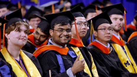 Student giving thumbs up at graduation ceremony