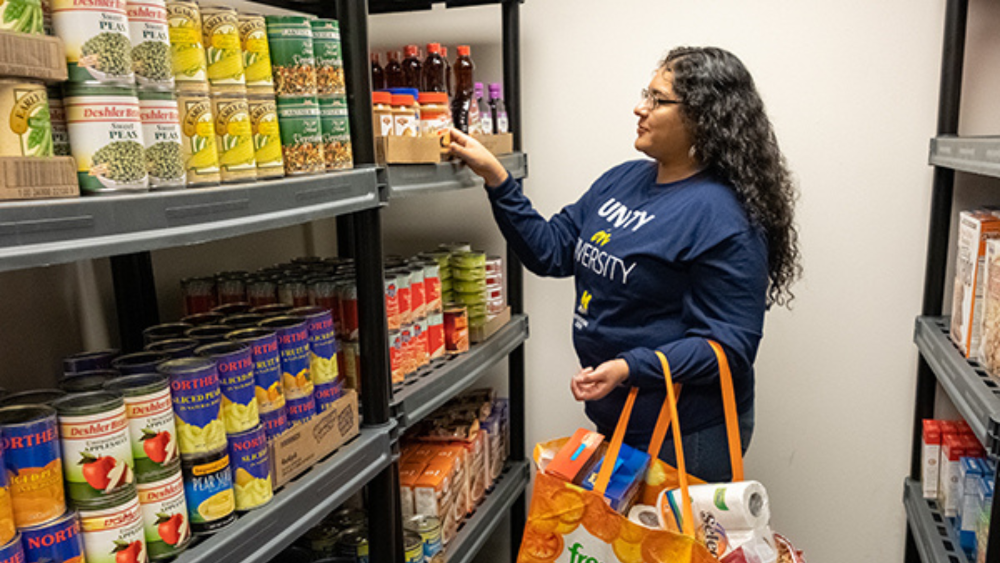 Student helping organize the food pantry