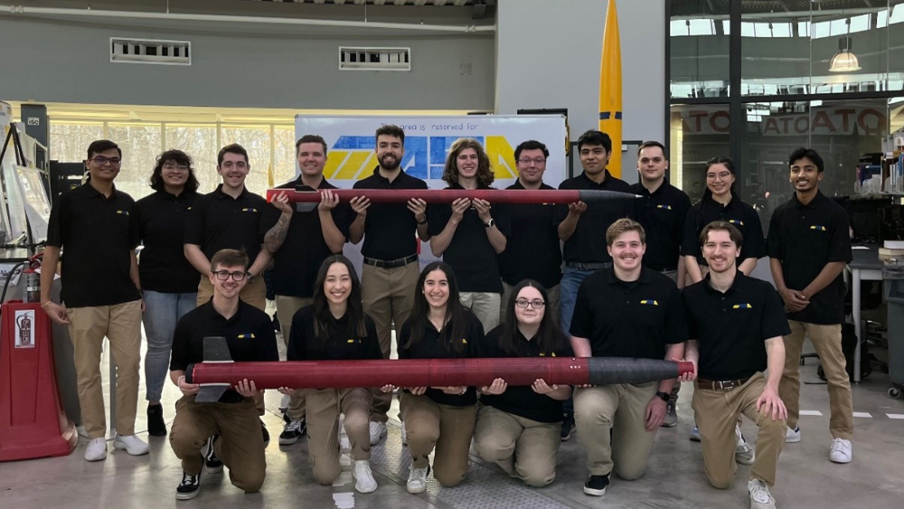 MASA in a team photo, holding their rockets