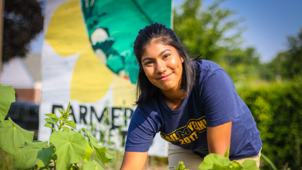 UM-Dearborn student tending to a community garden