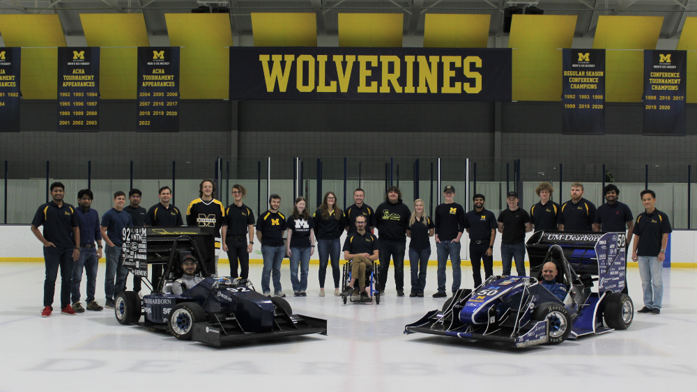 Formula SAE Electric Team standing in front of their formula-style race car 