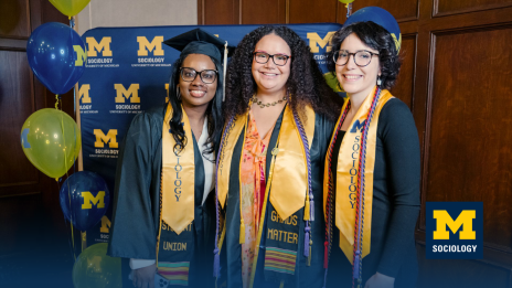 Sociology graduates pose with cap and gown