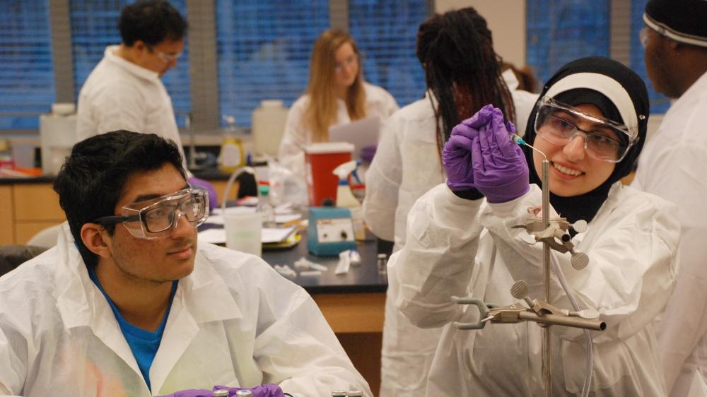 Two students doing an experiment in a lab