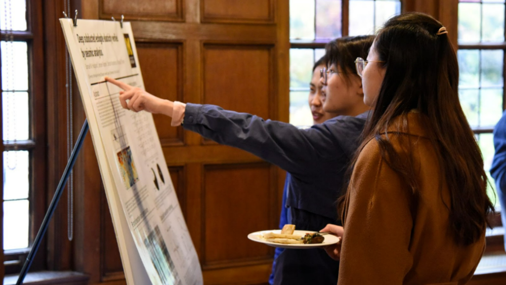 Three students at a poster session