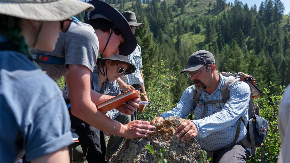 Students at Camp Davis working with faculty member