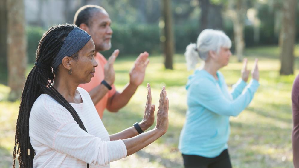 Group of older people performing Tai Chi
