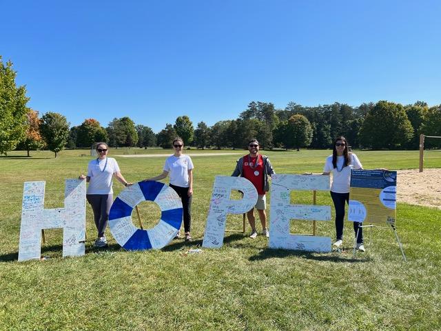 Students holding up letters 