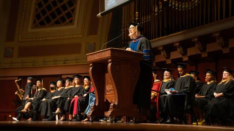 Dean Angell at the podium giving a speech at commencement
