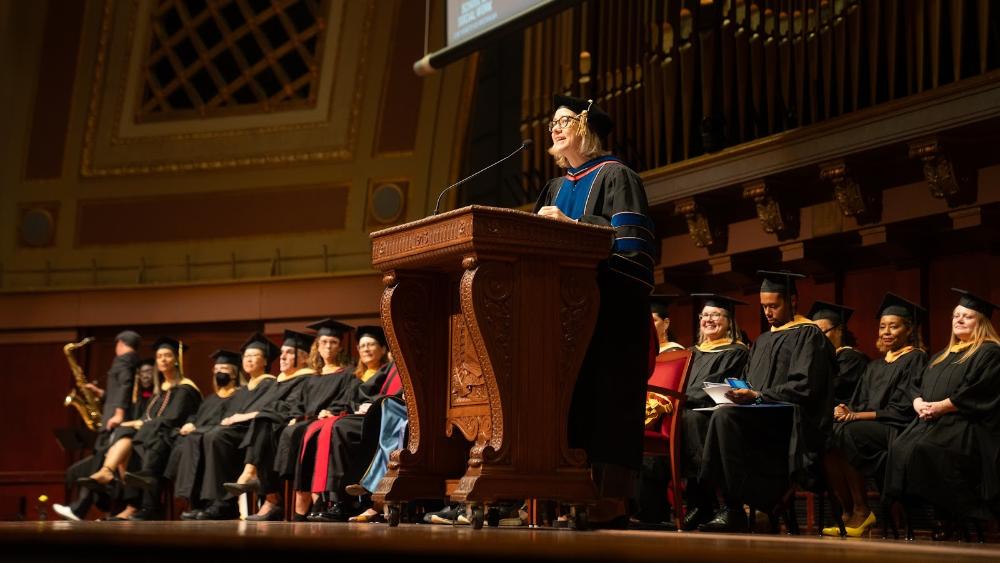 Dean Angell at the podium giving a speech at commencement