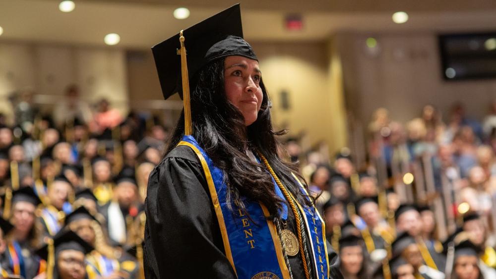 Student in cap and gown at commencement