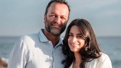 Samir and Puja Kaul standing on the beach.