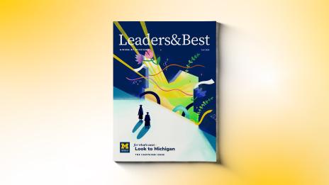 Cover of the Leaders & Best Fall 2024 special edition. It shows two students in graduation caps looking toward a bright future through a doorway shaped like the University of Michigan block M logo. 